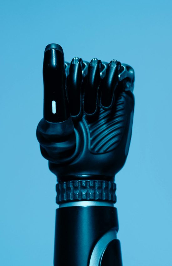 Close-up of a prosthetic arm in a vibrant blue setting, showcasing advanced technology.