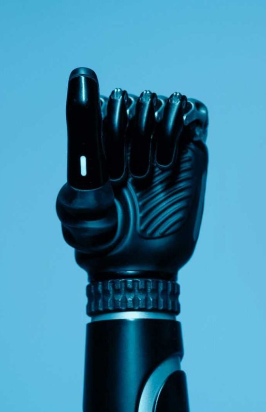 Close-up of a prosthetic arm in a vibrant blue setting, showcasing advanced technology.