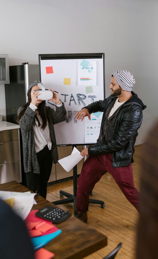 Dynamic scene of young entrepreneurs using VR technology in a startup setting.